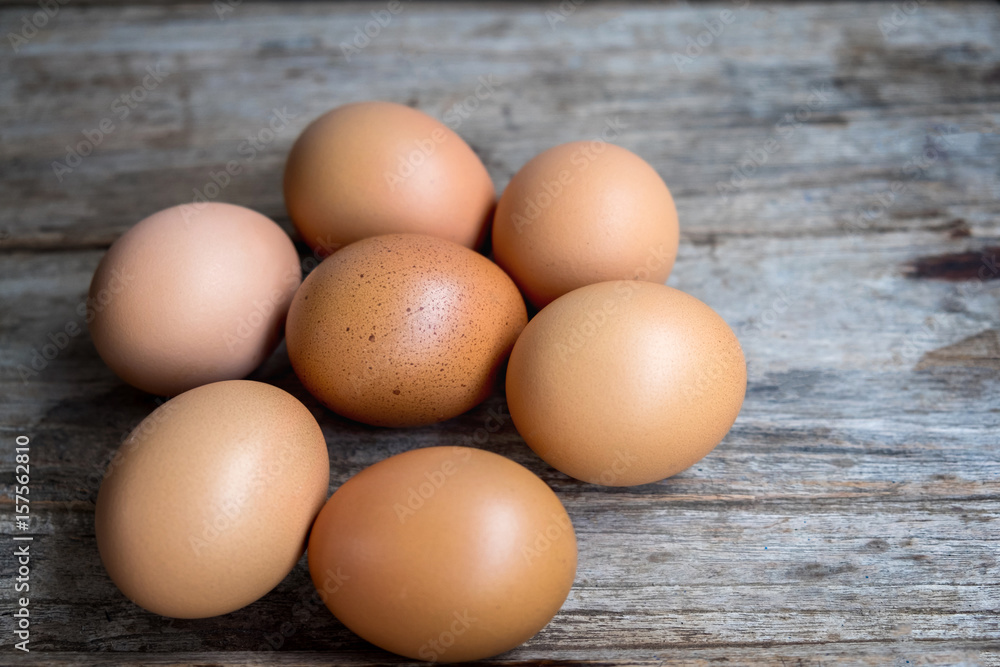 fresh eggs around Egg with dots on wooden background fresh eggs around Egg with dots on wooden background