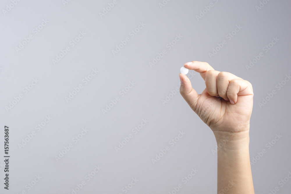 Fototapeta premium Hand holding medical pill