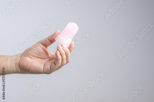 Tableau sur toile Hand holding natural mineral alum crystal stick use as underarm deodorant