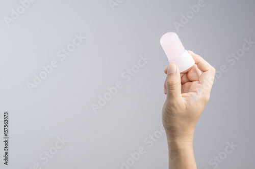 Photos Hand holding natural mineral alum crystal stick use as underarm deodorant