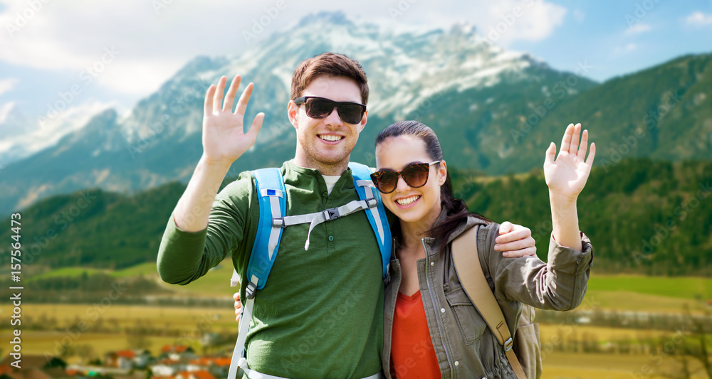 happy couple with backpacks traveling in highlands