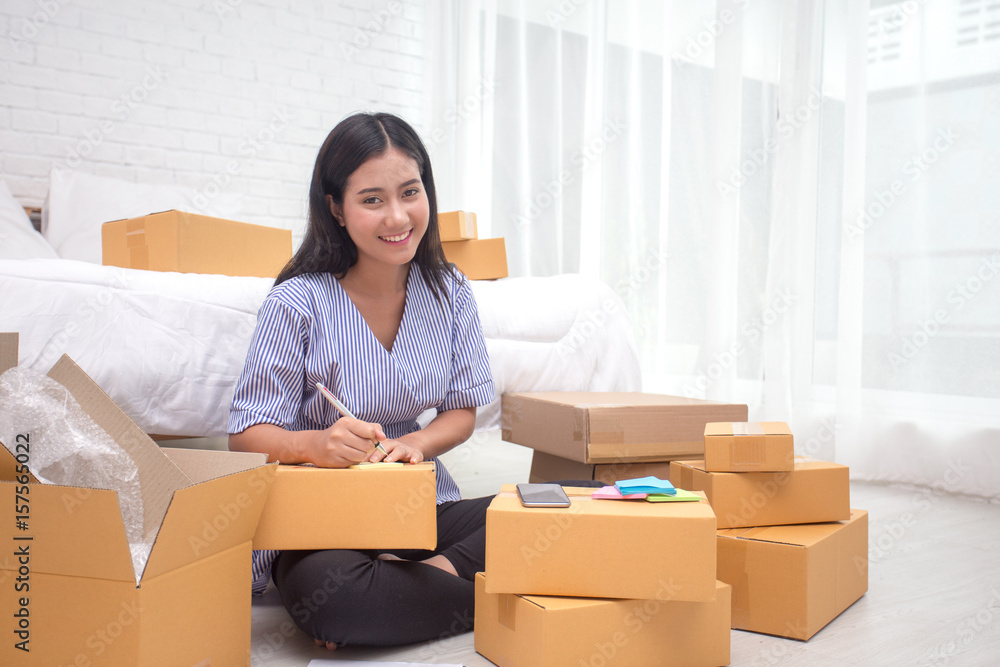 Young asian woman business owner work and white down address for deliver at home, woman business owner concept, 20-25 year old. Young asian woman business owner work and white down address for deliver at home, woman business owner concept, 20-25 year old.