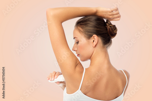 woman with antiperspirant deodorant over white photo