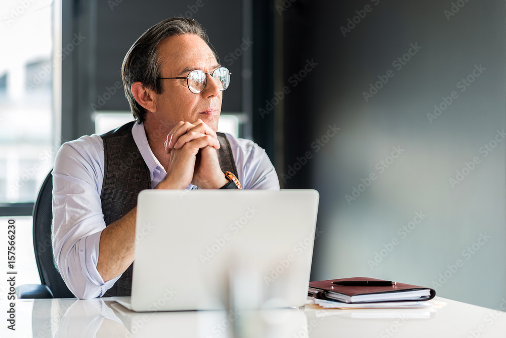 Confident senior man working in office Confident senior man working in office