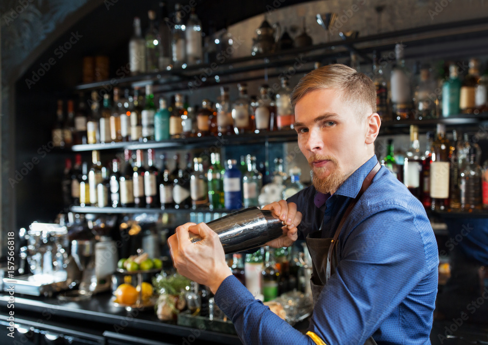 barman with shaker preparing cocktail at bar