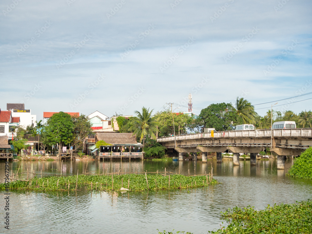 Vietnamese houses on a river, floating market and boats, traditional way of life, Hoi An town, central Vietnam Vietnamese houses on a river, floating market and boats, traditional way of life, Hoi An town, central Vietnam