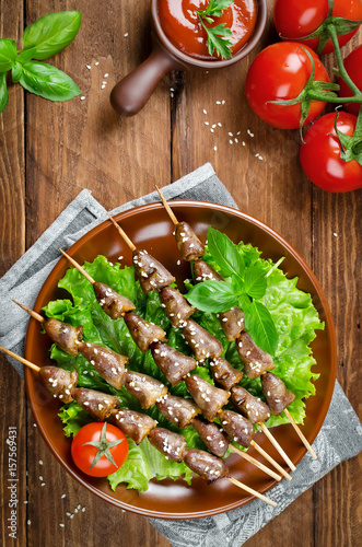 Chicken hearts on a barbecue sticks topped with sesame seeds