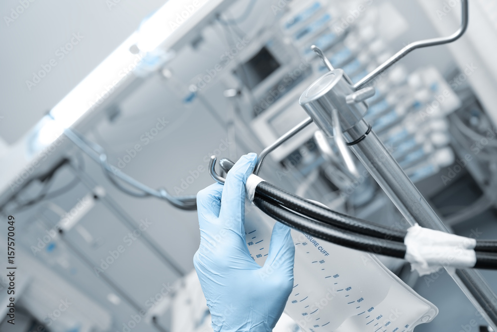 Doctor sets equipment in the ICU Doctor sets equipment in the ICU
