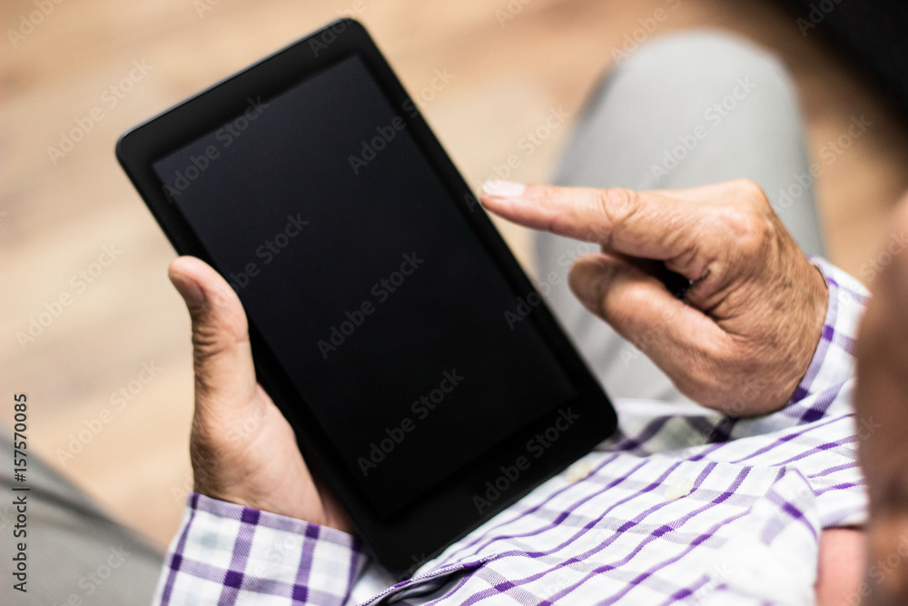 Senior using modern digital tablet