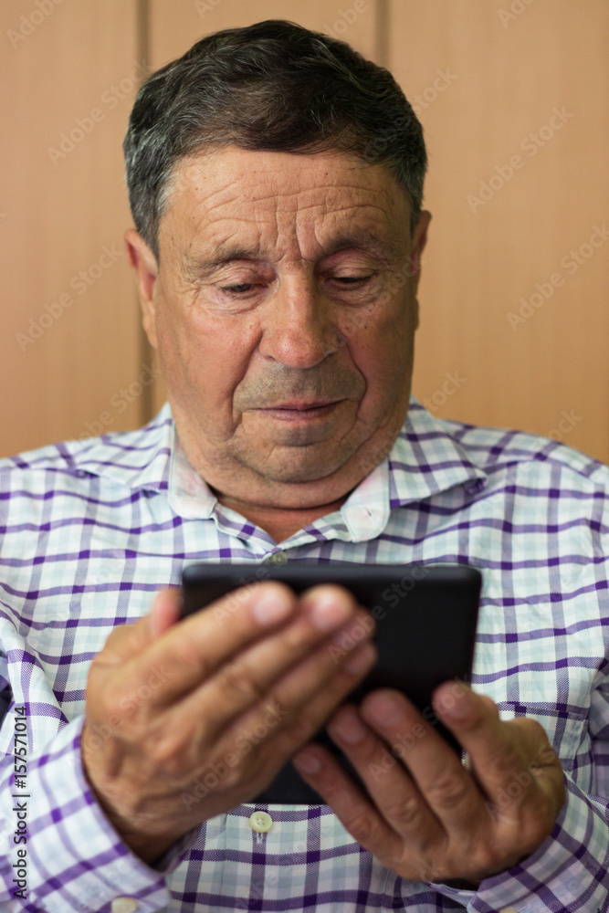 Senior using modern digital tablet Senior using modern digital tablet