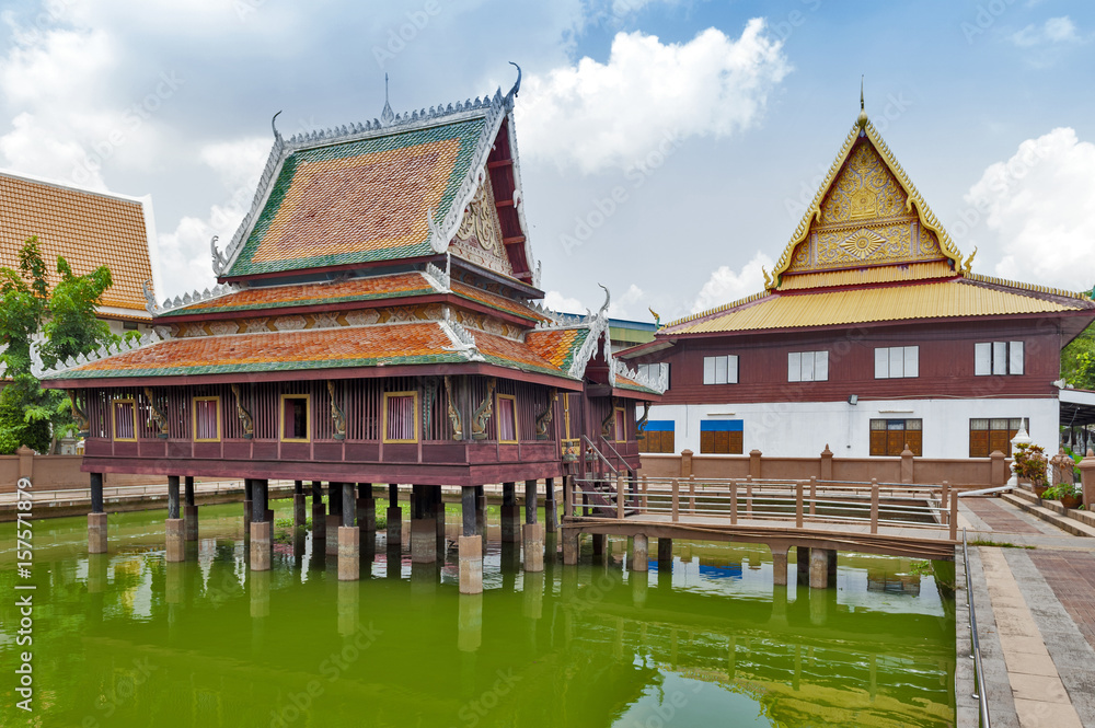 Ho Trai - Traditional Thai-style building used as a library that houses Buddhist scriptures (Tripitaka or Pali Canon) located at Wat Mahathat Temple in downtown Yasothon, Thailand