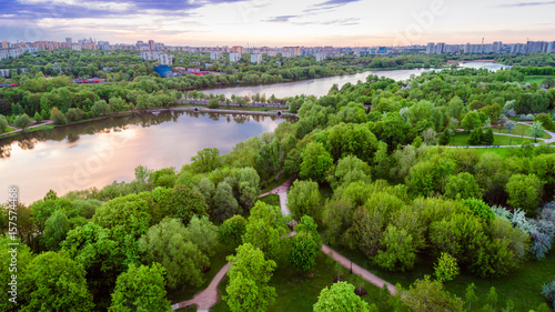 Aerial view of Tsritsyno lake - Moscow city in Russia. Park. Multi-storey buildings in the background. Sunset. Urban view.