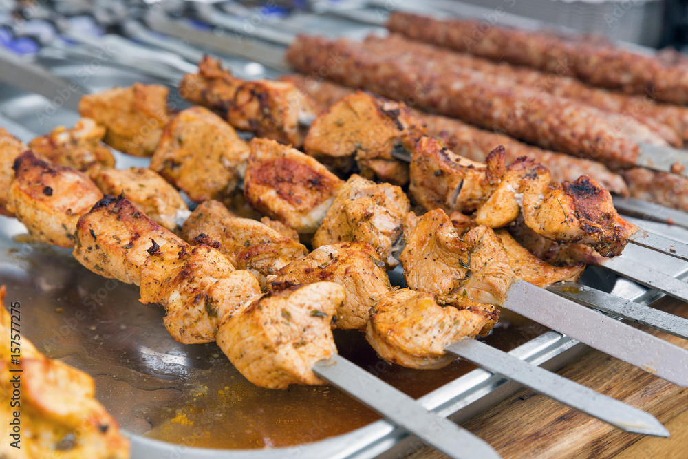 Shish kebab on skewers fried on a grill outdoors