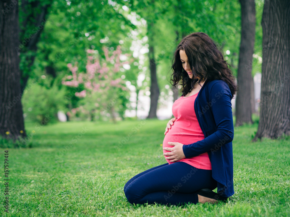 Pregnant womant looking at belly Pregnant womant looking at belly