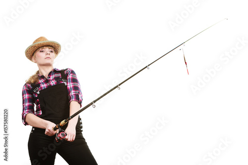 Focused woman in sun hat holding fishing rod photo