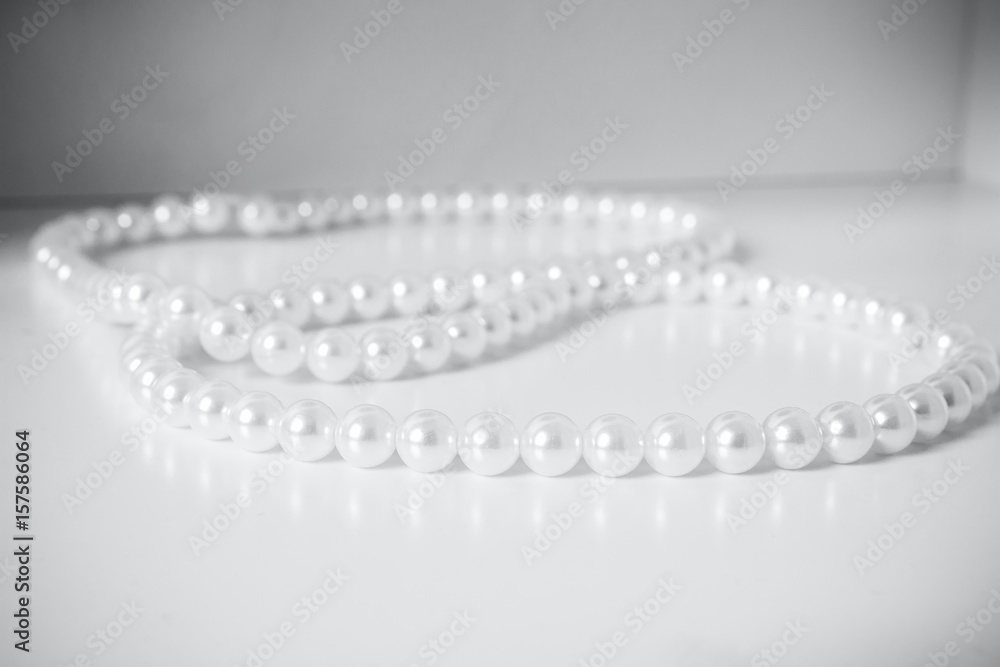 Beads from pearls on a white table
