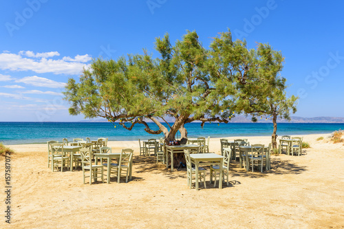 Fotografia Romantic greek tavern on the Plaka beach. Naxos island, Greece.