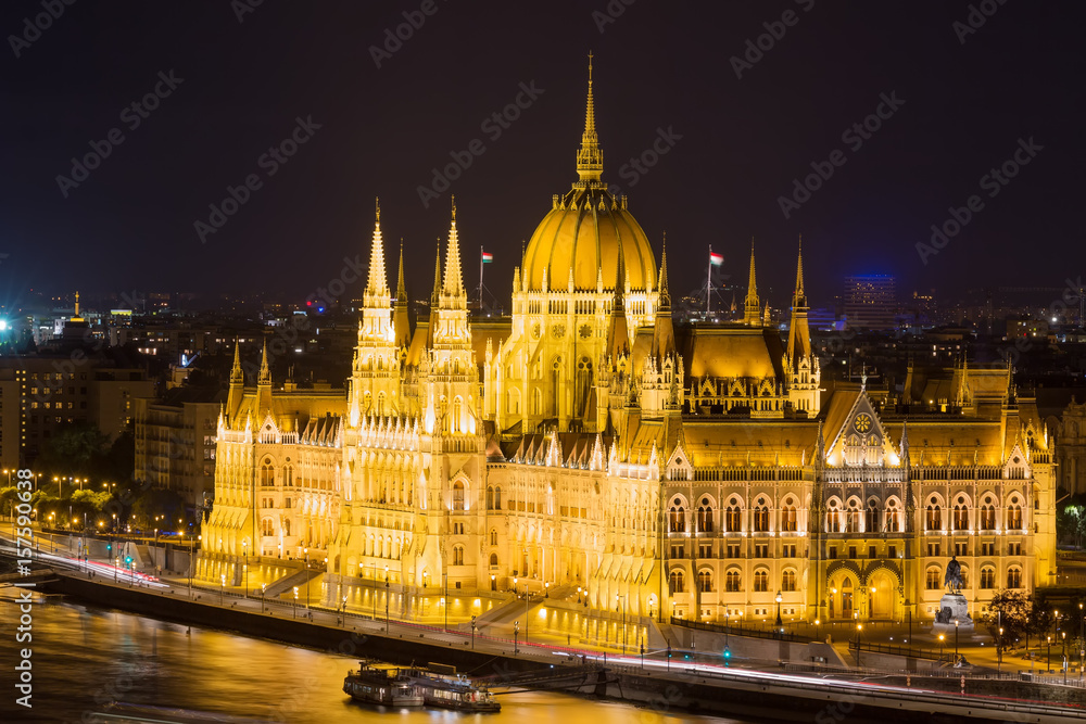 Budapest parliament building at night with dark sky and reflection in Danube river