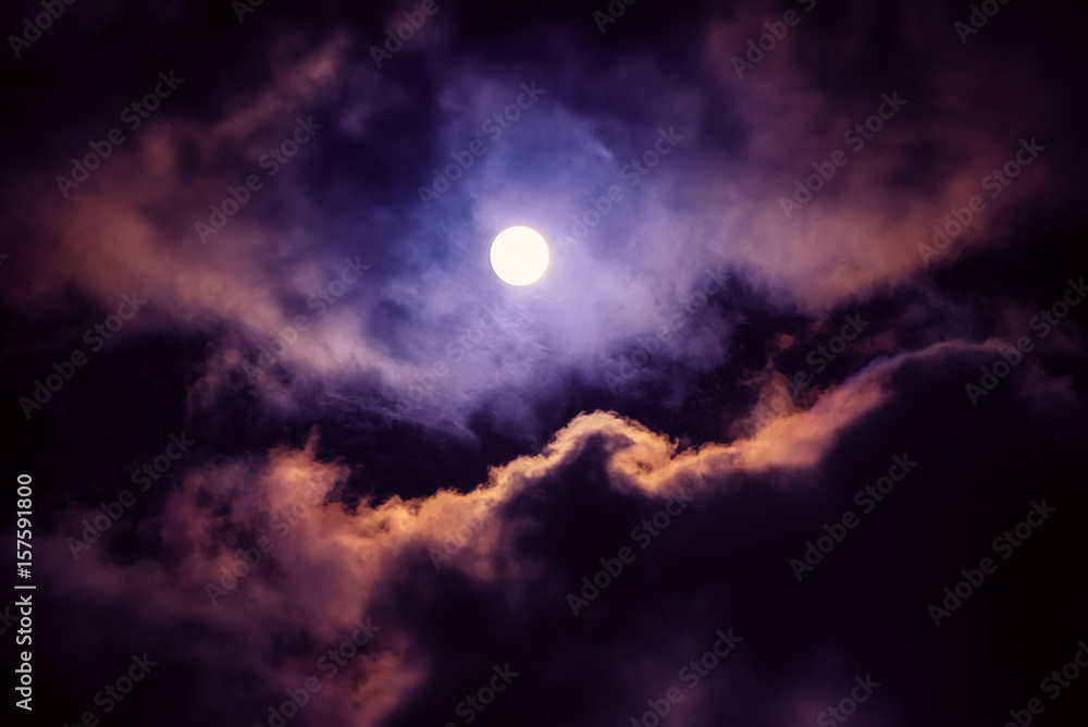 Obraz premium The moon on the dark sky among the clouds, natural abstract background