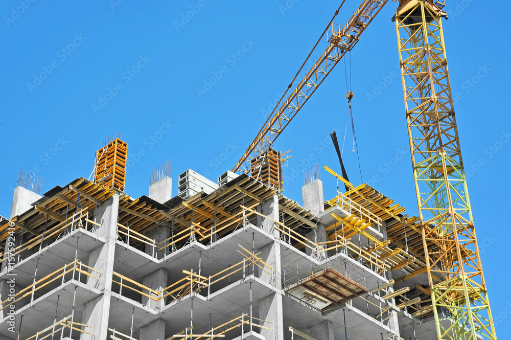 Crane and highrise construction site Crane and highrise construction site