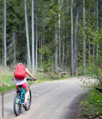 Fototapeta Naklejka Na Ścianę i Meble -  girl with red bag on the forest bike trip