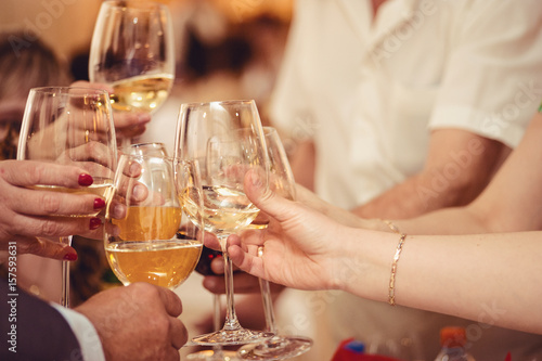 Celebration. Hands holding the glasses of champagne and wine making a toast.