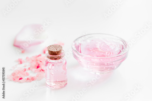 rose organic cosmetics with salt, cream and oil on white table background