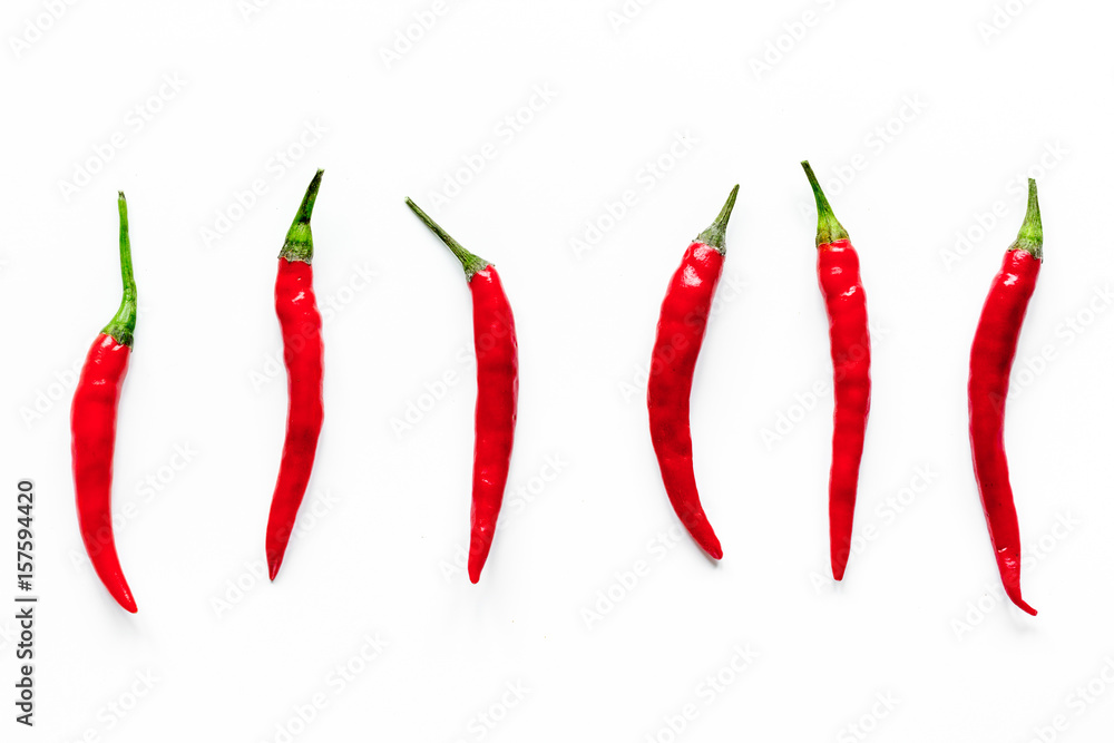 red hot chili pepper design on white table background top view