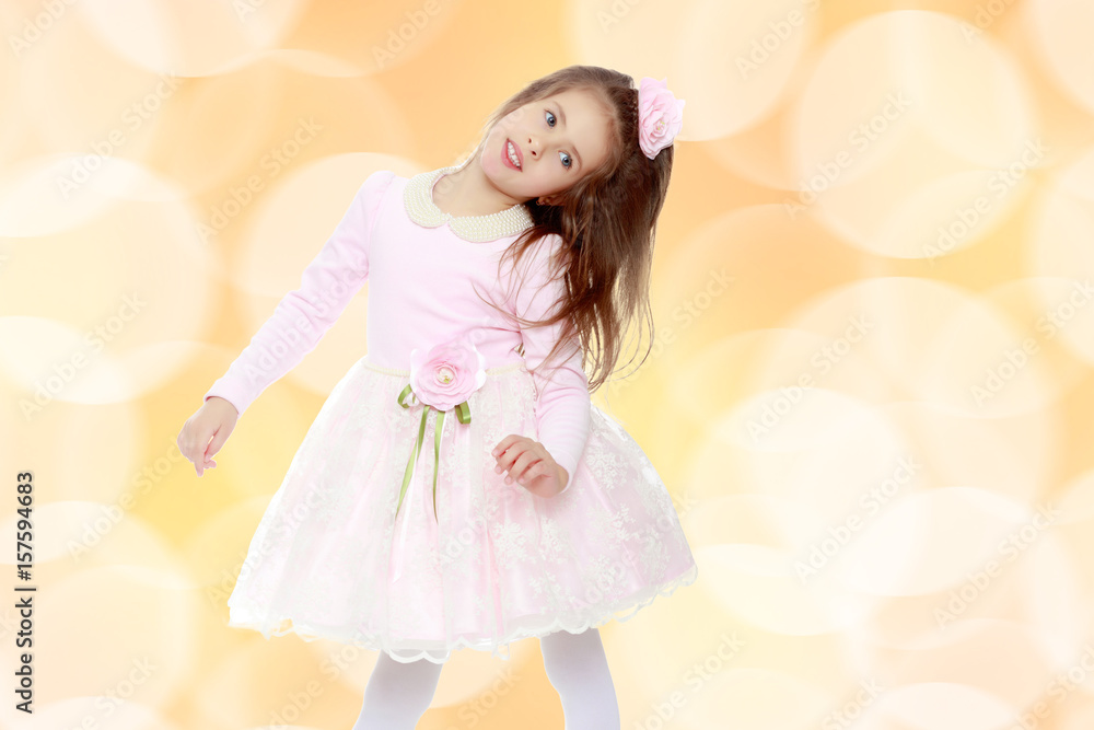 Elegant little girl in a pink dress. Elegant little girl in a pink dress.