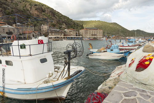 MARCH 2, 2014 CANAKKALE TURKEY.The ancient harbor of the ASSOS.Small fishing boats and fishhermans nets lies on the dock.