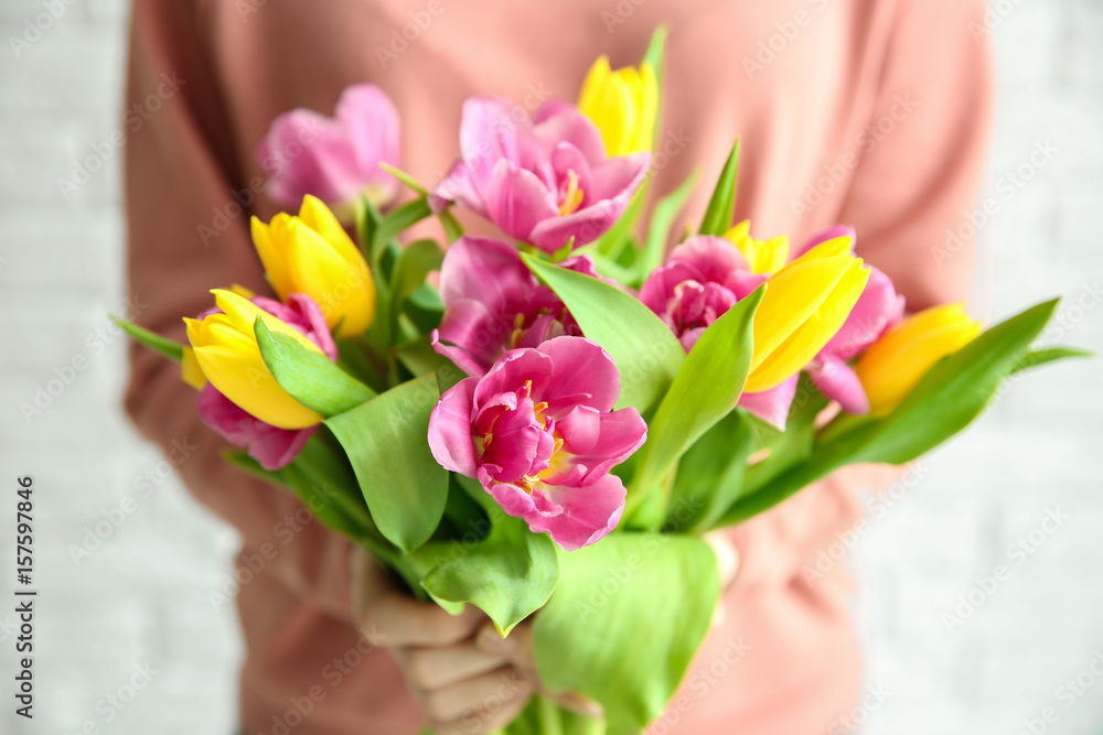 Woman holding beautiful bouquet of tulips, closeup