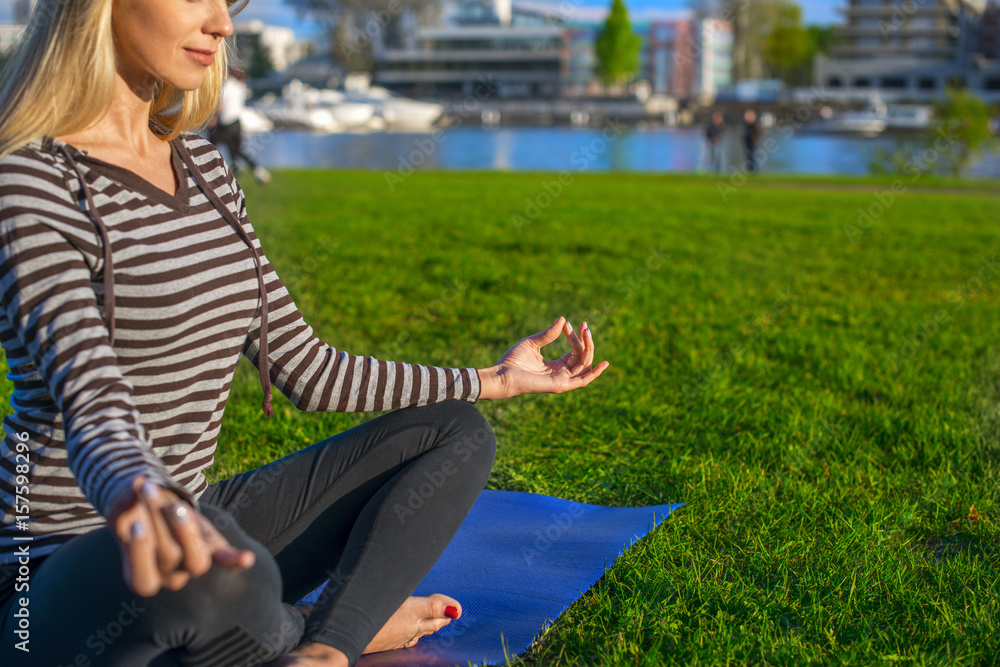 Fototapeta premium Sporting woman in a half-turned Lotus pose