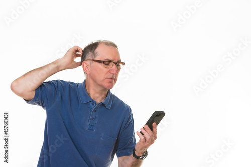 Confused older man with cell phone isolated on white