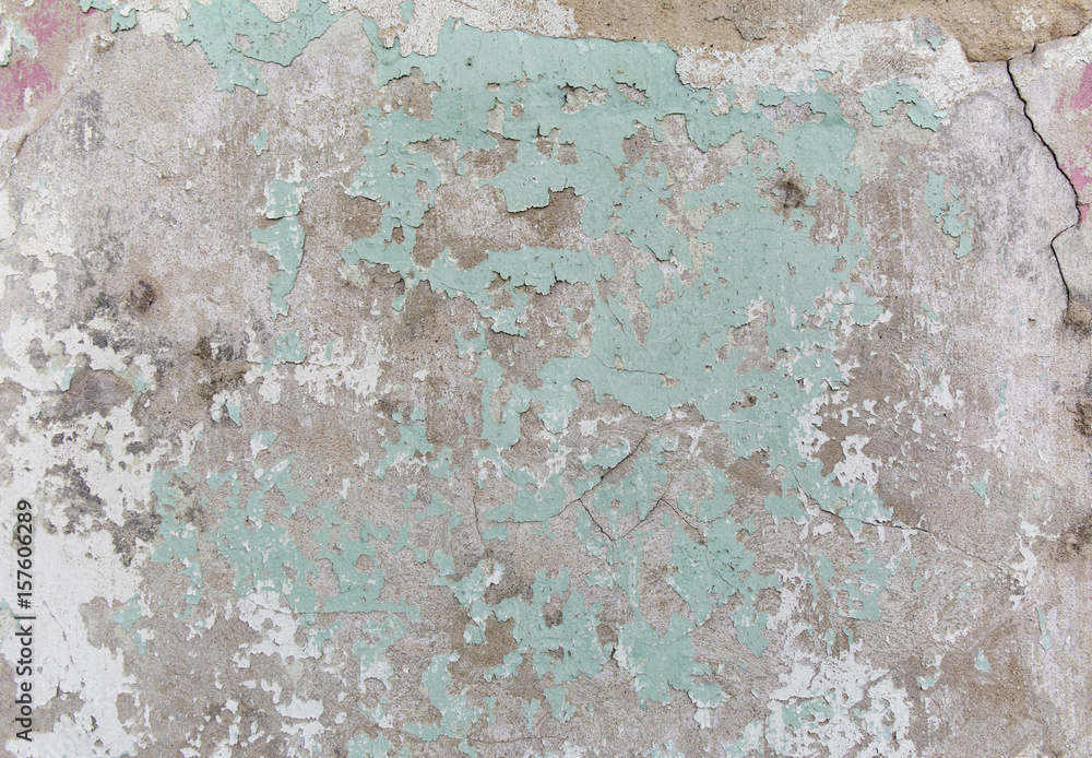 Old painted wall. Green and damage surface. Peeling paint background. Stone demaged backdrop.