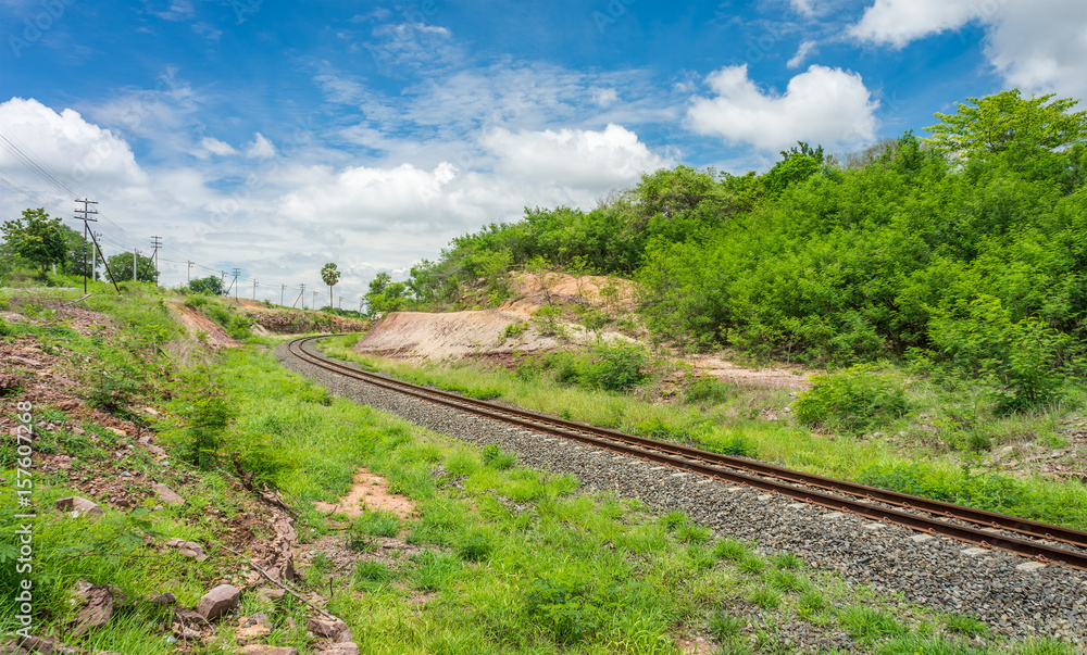 Curved train track with blue sky. The rail transport in rural of Thailand.