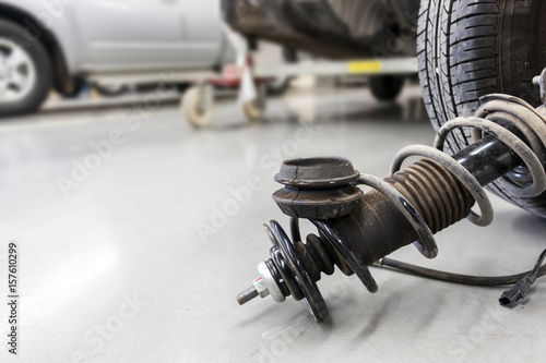 closeup wheels and shock absorbers with repair the suspension on the car. soft-focus and over light photo