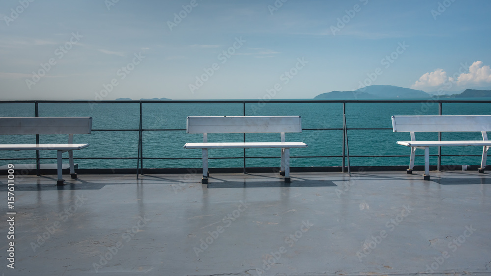 White wooden bench and sea view.
