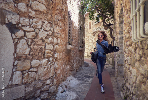 Girl, model running down the street of the old city. Fashion, style, travel.