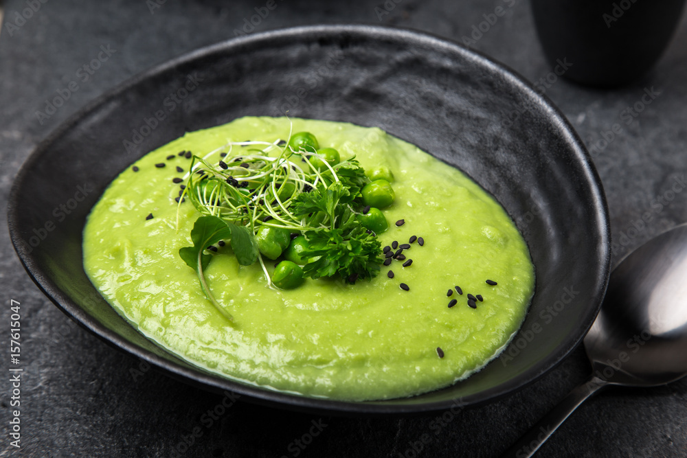 delicious green peas cream soup, dark background delicious green peas cream soup, dark background