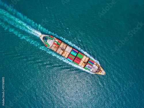 container ship in import export and business logistic.By crane ,Trade Port , Shipping, cargo to harbor, Aerial view, Top view. © MAGNIFIER
