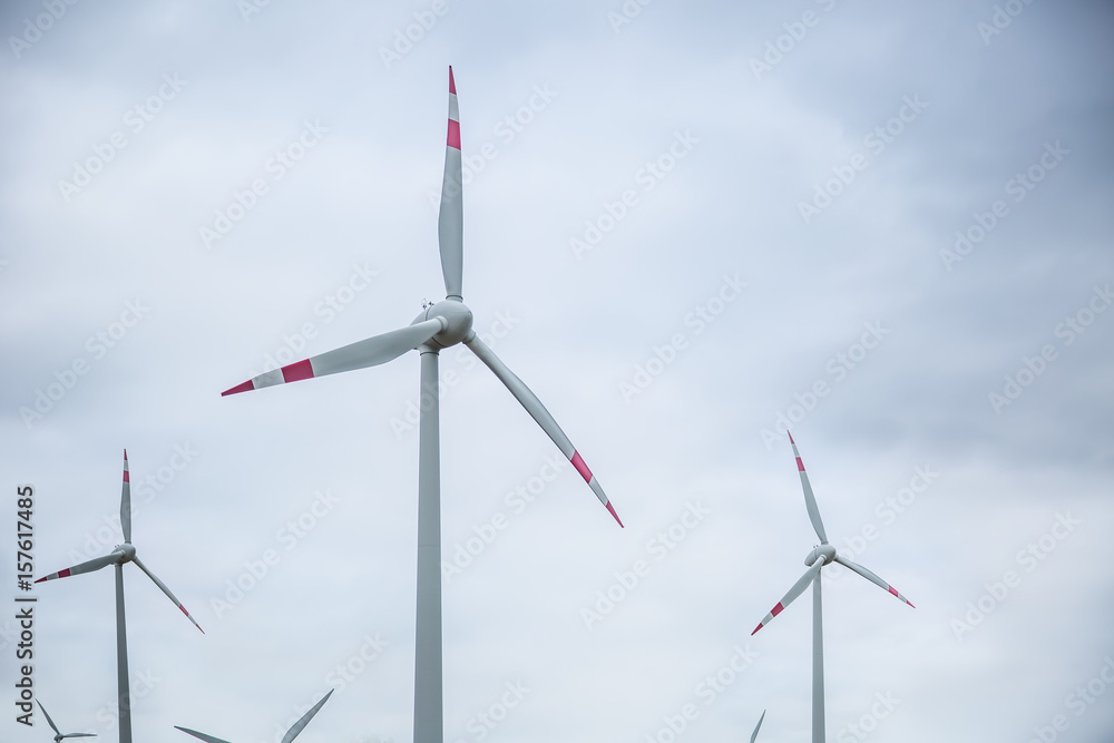 Wind power. Wind energy. Electrical energy. Several wind turbines in power generation.