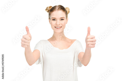 happy attractive woman in white t-shirt with thumbs up looking at camera isolated on white © LIGHTFIELD STUDIOS