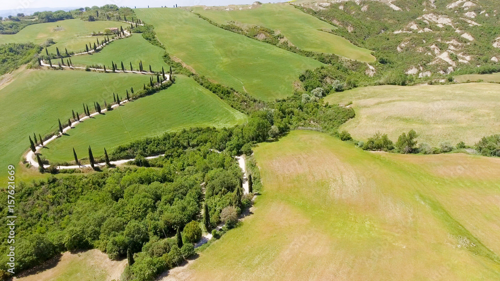 Amazing aerial view of Tuscany countryside winding road in spring season - Italy