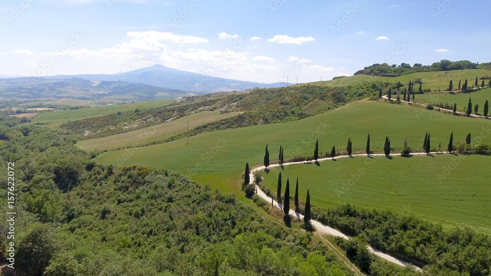 Amazing aerial view of Tuscany countryside winding road in spring season - Italy