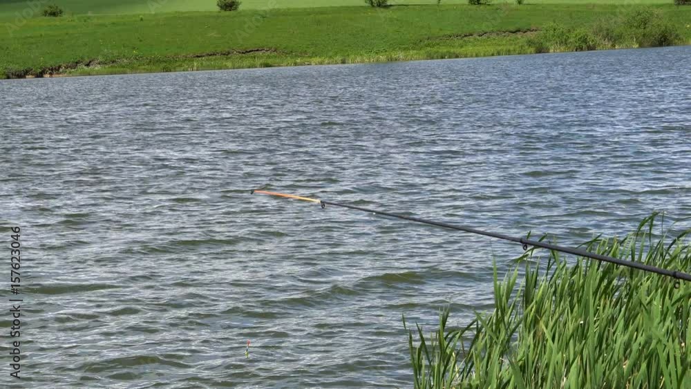 Fishing Pole waiting for fish to bite bait. Fishing Pole waiting for fish to bite bait.