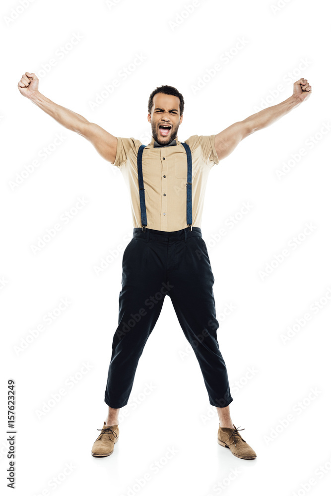 cheerful african american man wearing in suspenders and bow tie yelling and celebrating success isolated on white cheerful african american man wearing in suspenders and bow tie yelling and celebrating success isolated on white
