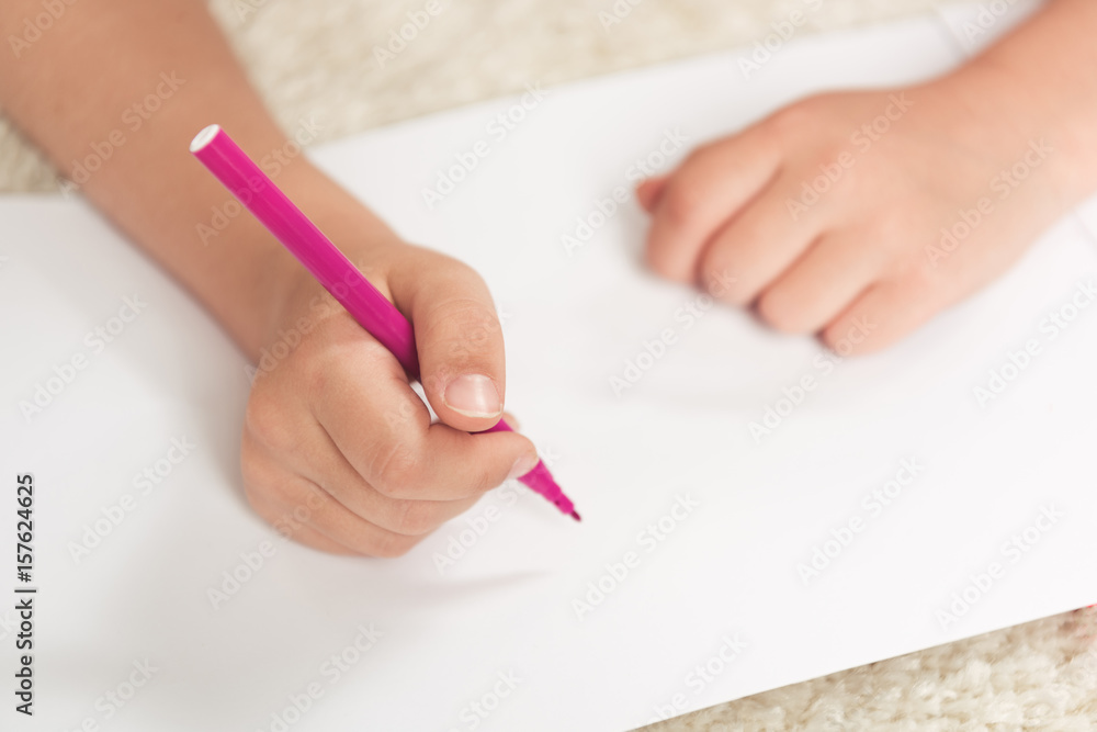 cropped shot of kid drawing with felt pen on blank paper sheet cropped shot of kid drawing with felt pen on blank paper sheet