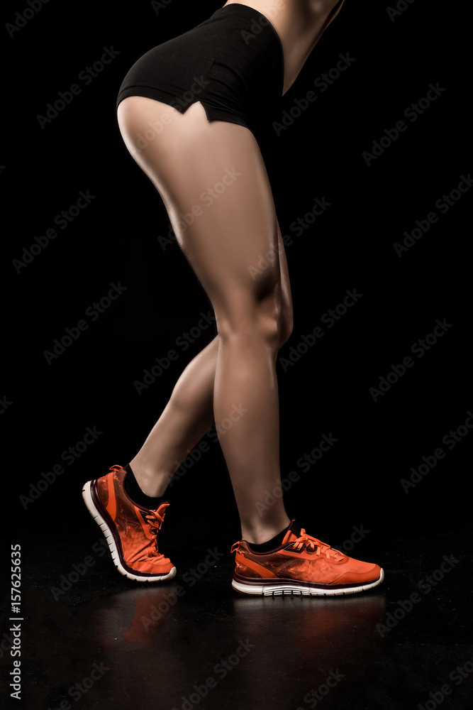 cropped shot of muscular woman in sportswear isolated on black cropped shot of muscular woman in sportswear isolated on black