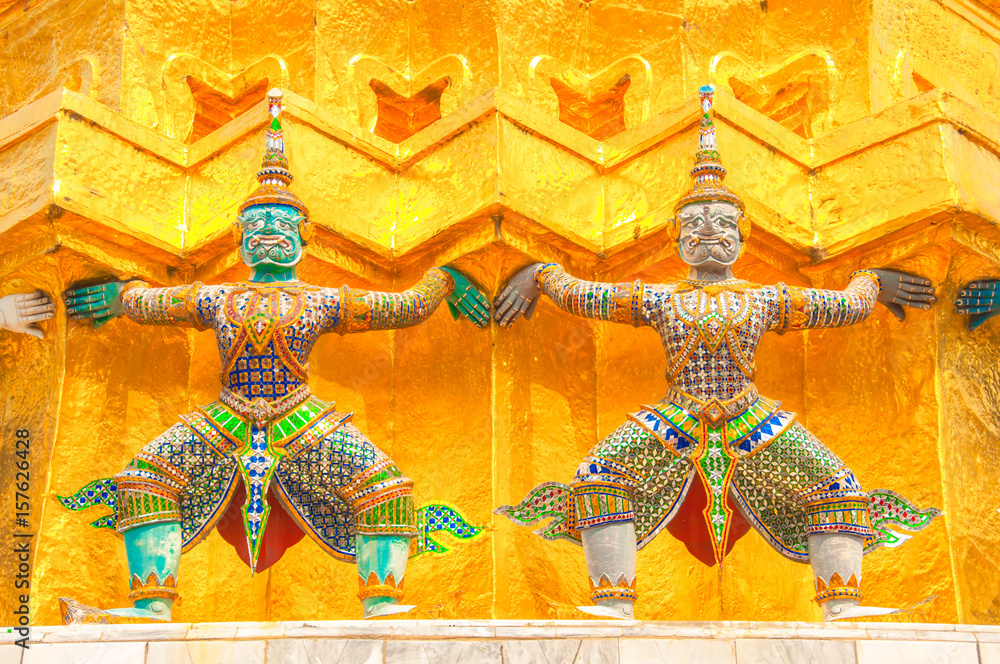 Giants under golden pagoda, Warrior statue at The Grand Palace and the temple Wat Phra Kaeo. Bangkok. Thailand.