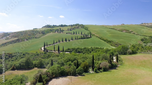 Amazing aerial view of Tuscany countryside winding road in spring season - Italy